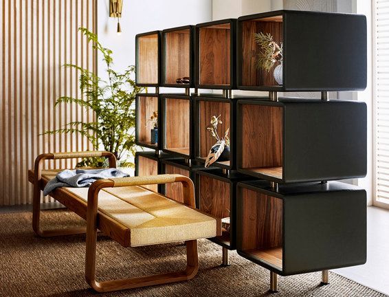 A living room with a bench and a bookshelf.