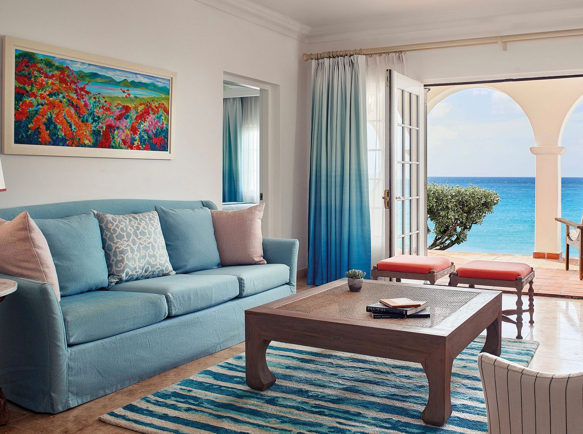A living room with a blue couch and a coffee table