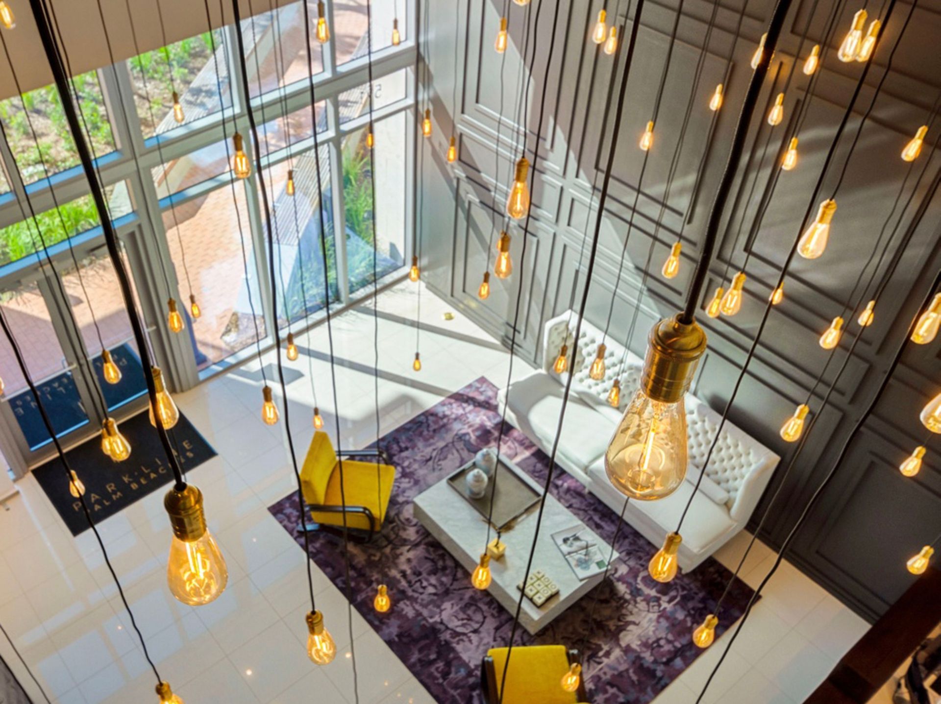 An aerial view of a living room with lots of lights hanging from the ceiling.