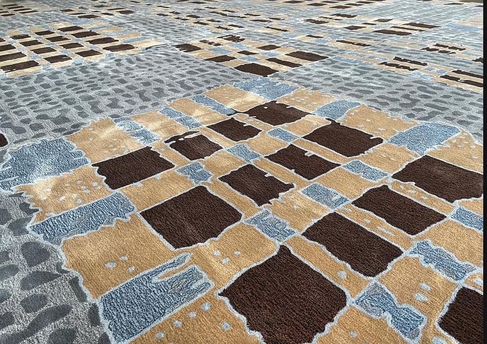 A close up of a carpet with a checkered pattern on it.