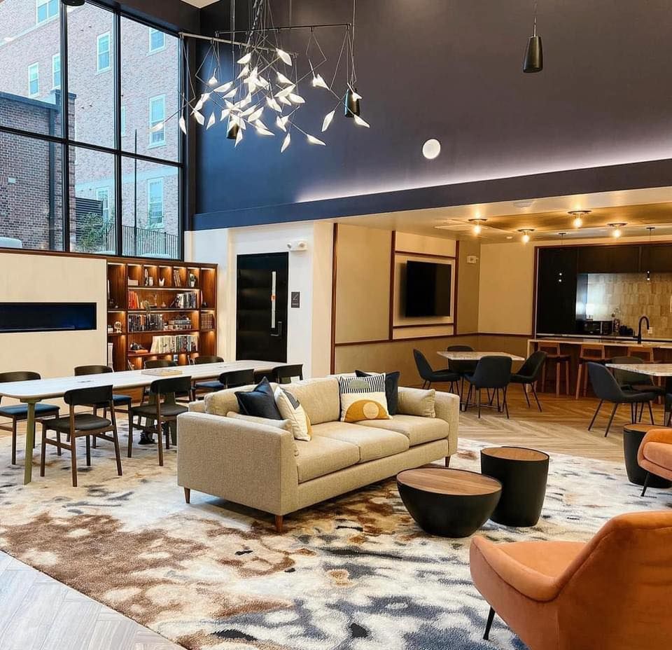 A living room with a couch and chairs in it