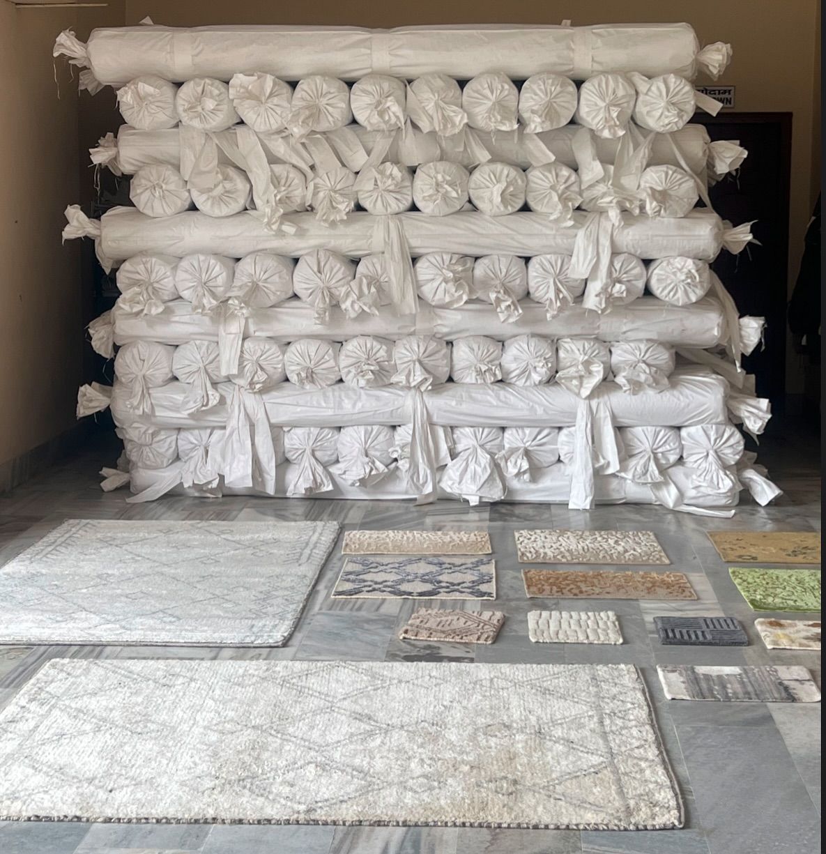 A room with a lot of rolls of fabric stacked on top of each other