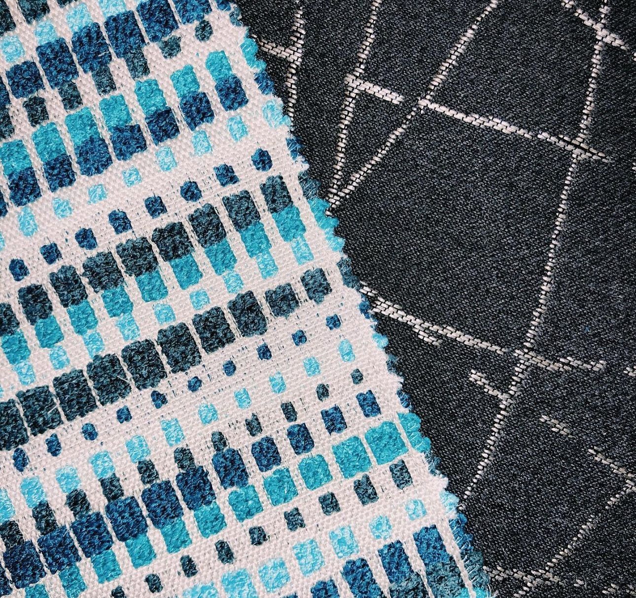 A close up of a blue and black rug on a table.