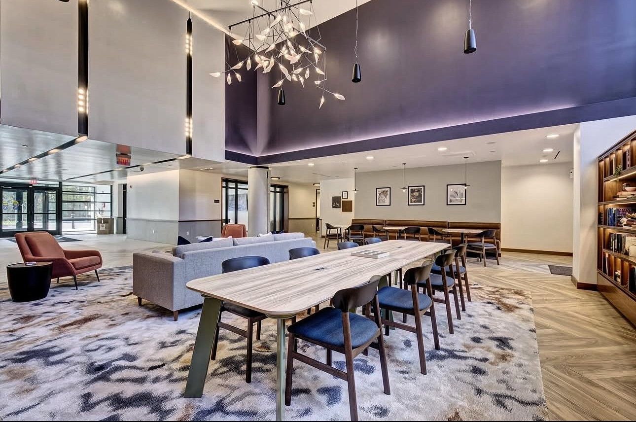 A large room with a table and chairs in it