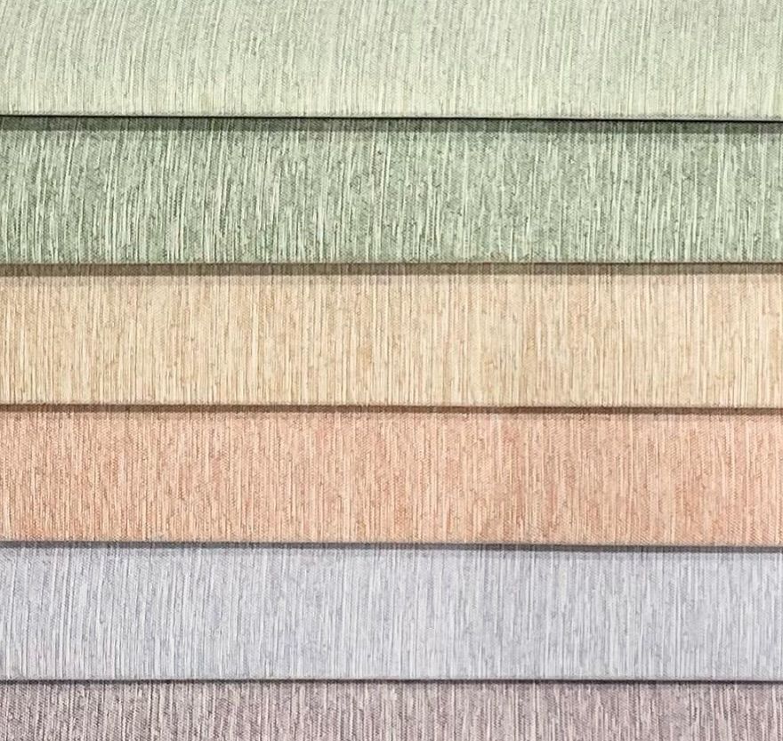A close up of a stack of different colored fabrics.
