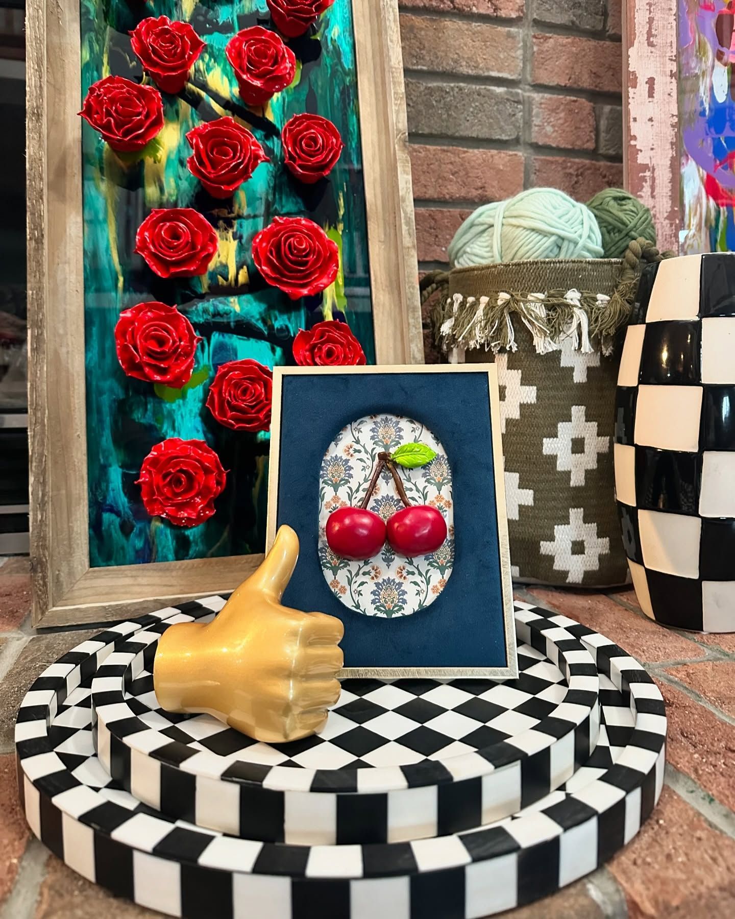 A black and white checkered plate with a picture of a cherry and a hand giving a thumbs up