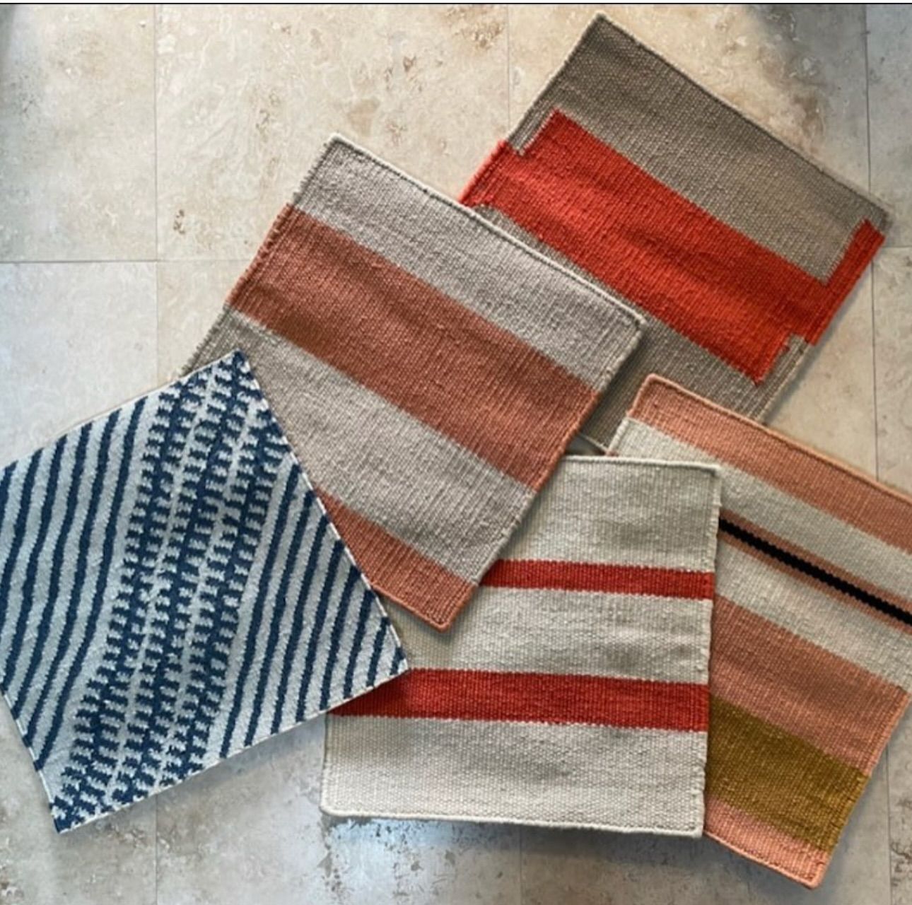 A bunch of striped rugs are laying on the floor
