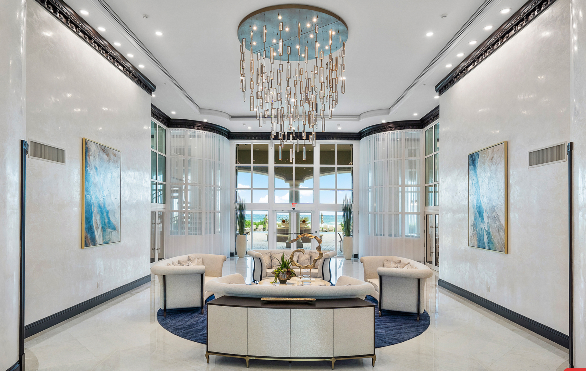 There is a large chandelier in the middle of the room.