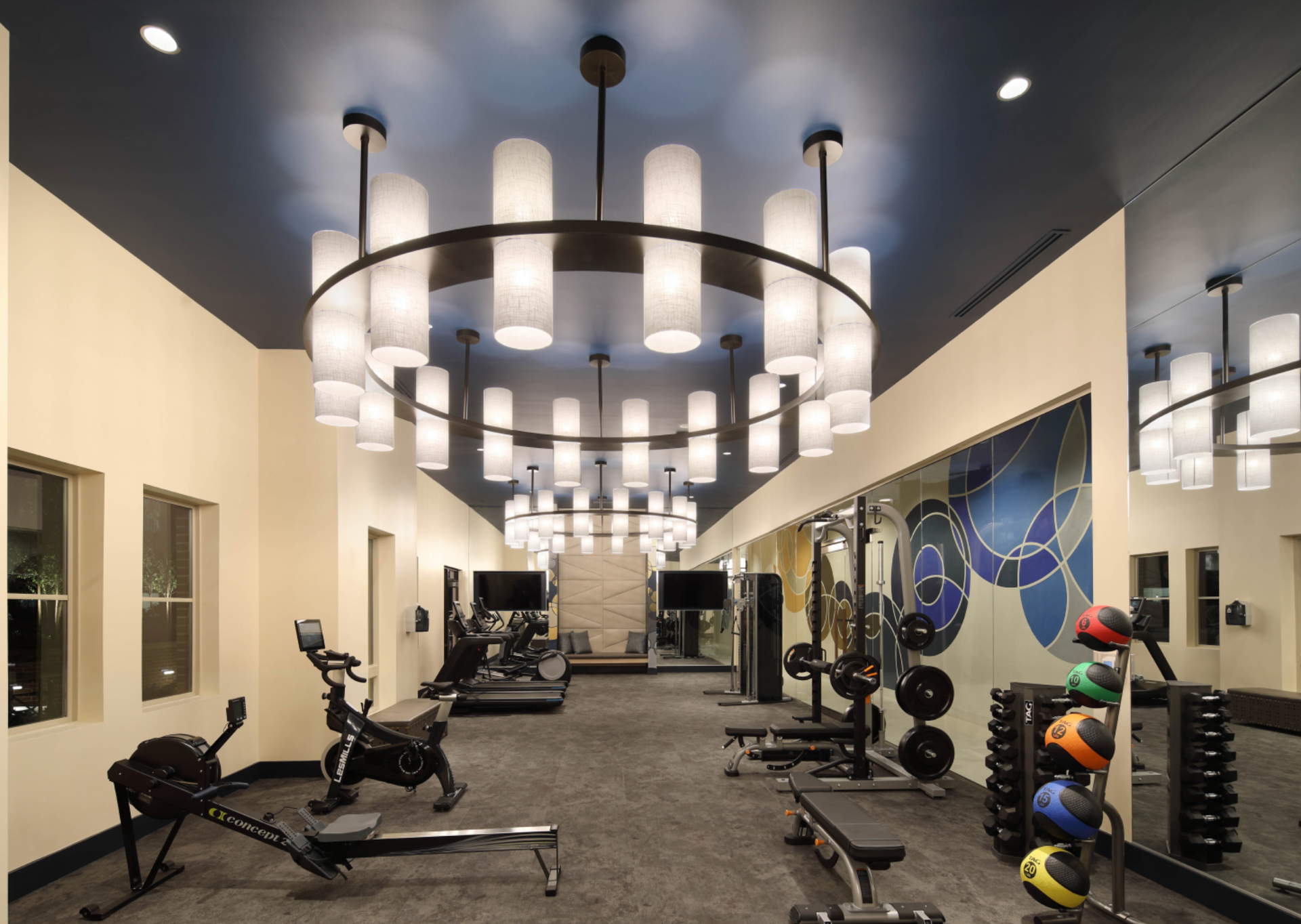 A large gym with a chandelier hanging from the ceiling