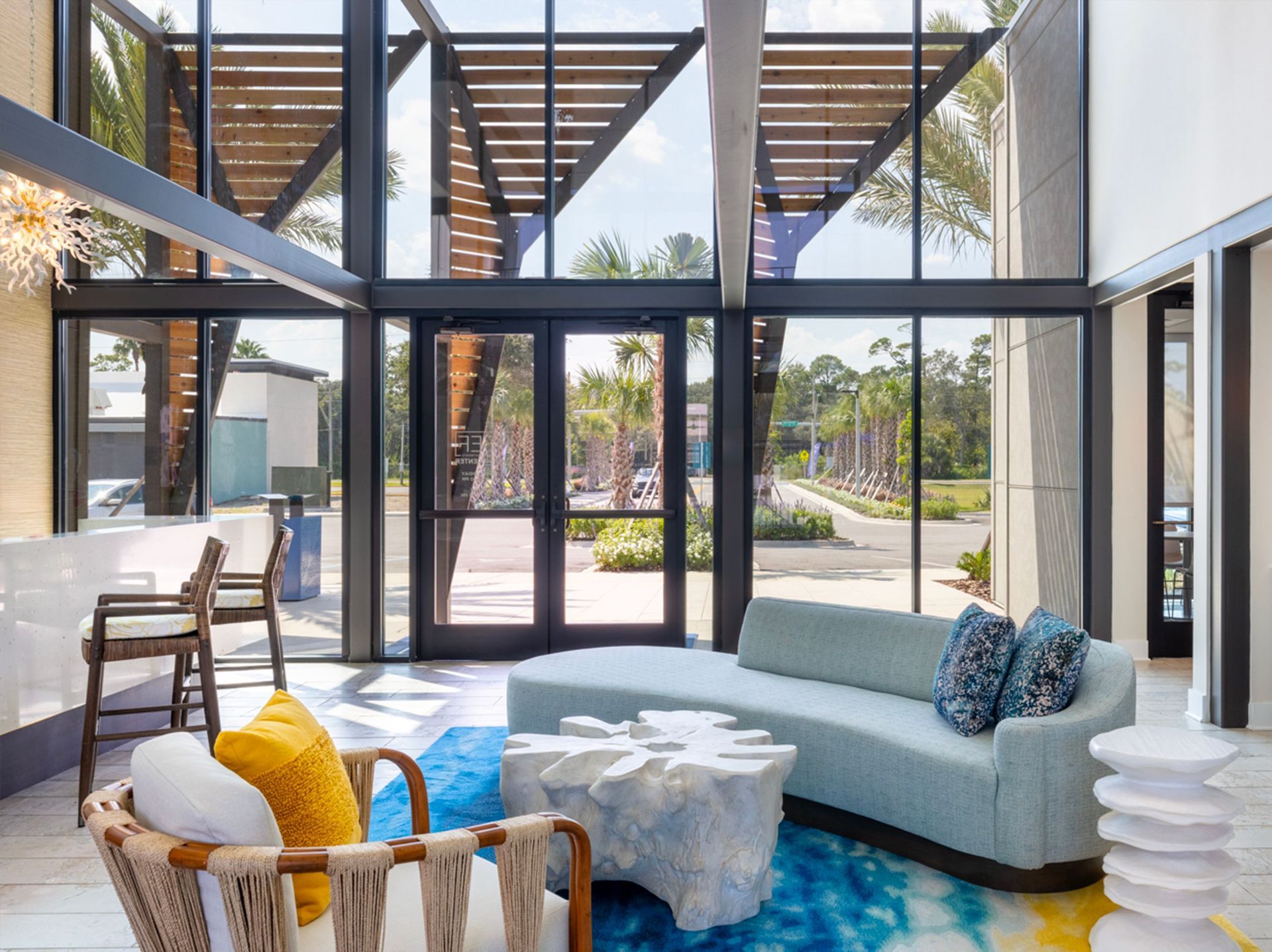 A living room with a couch , chairs , and a table.