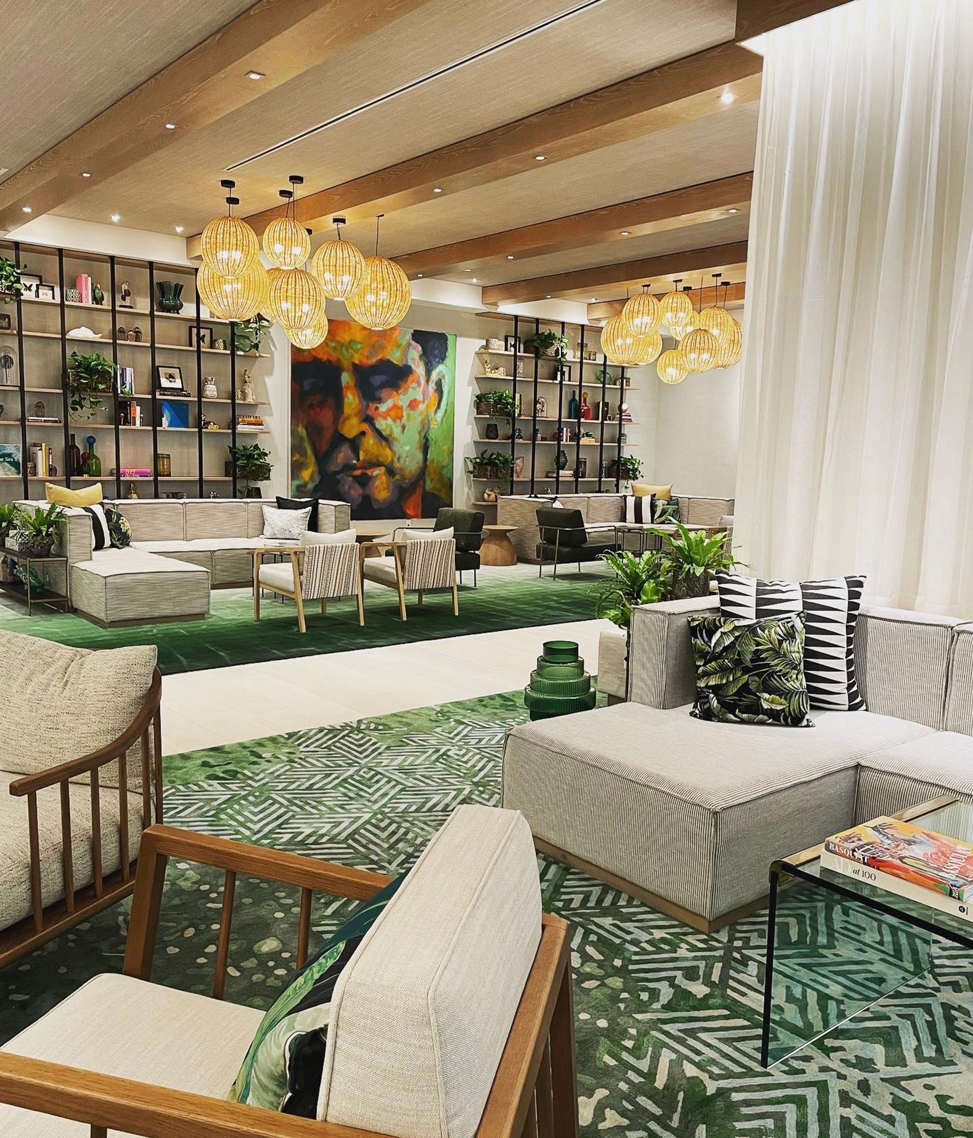 A living room filled with furniture and a green rug.