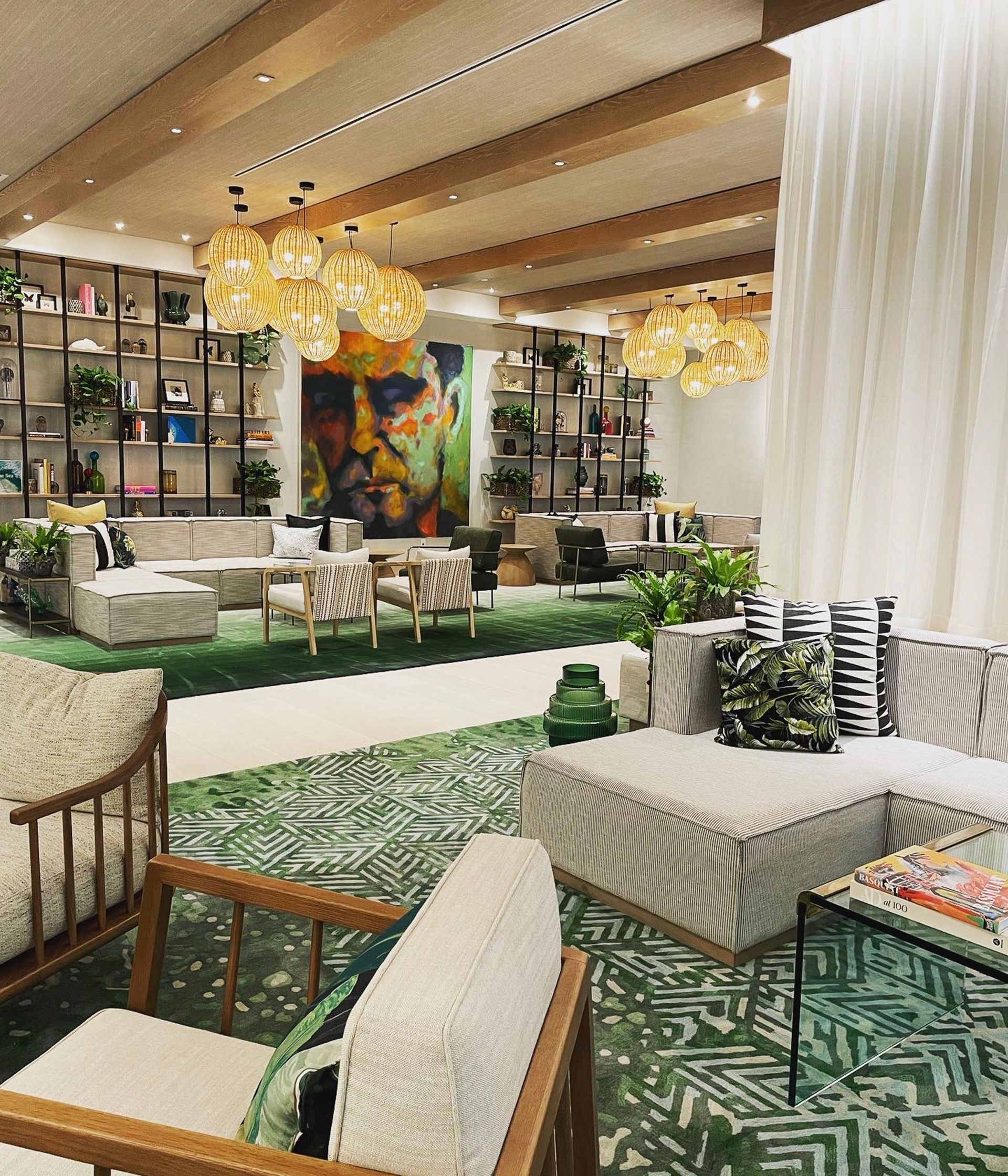 A living room filled with furniture and a green rug.
