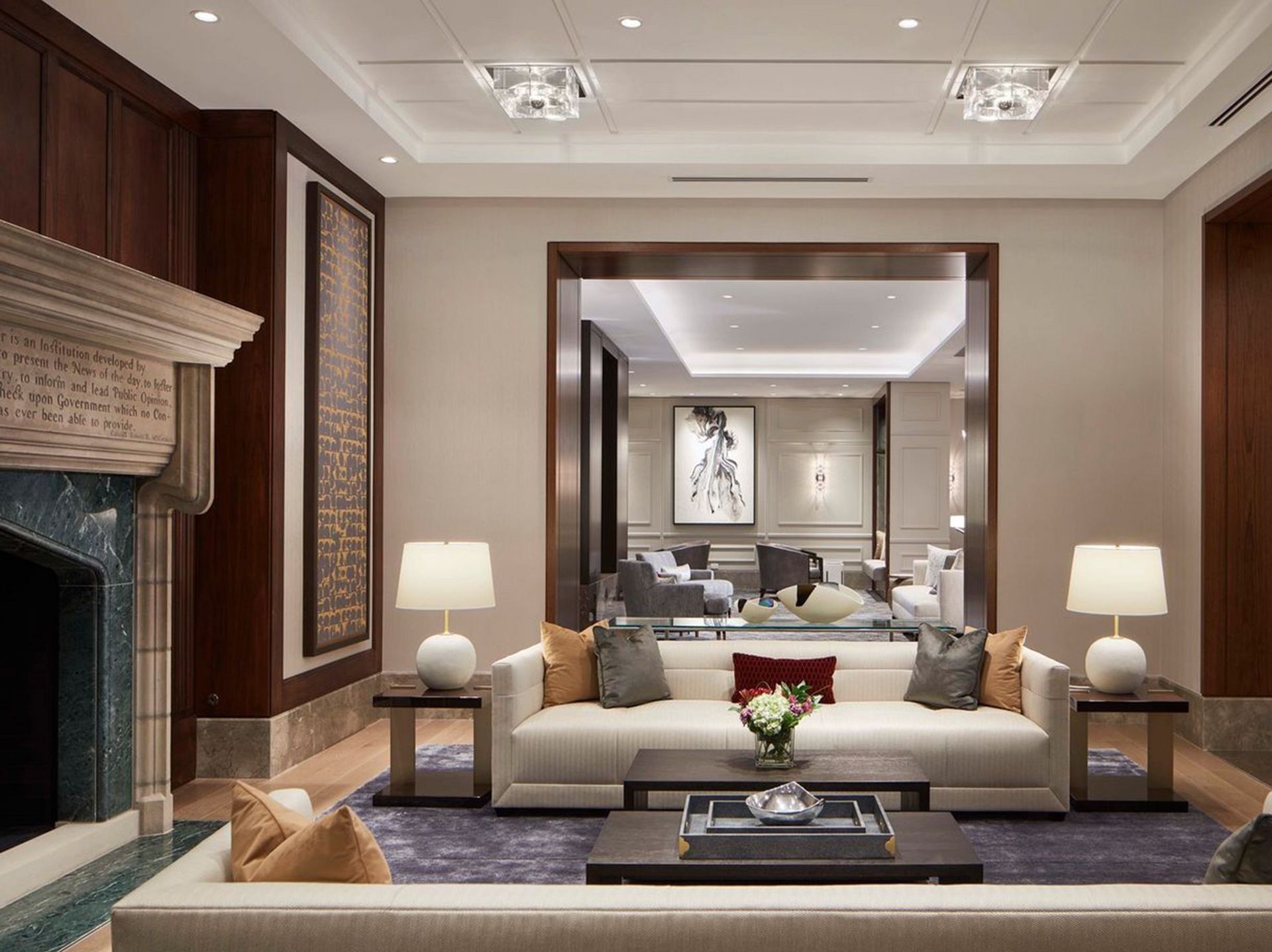 A living room with a white couch and a fireplace