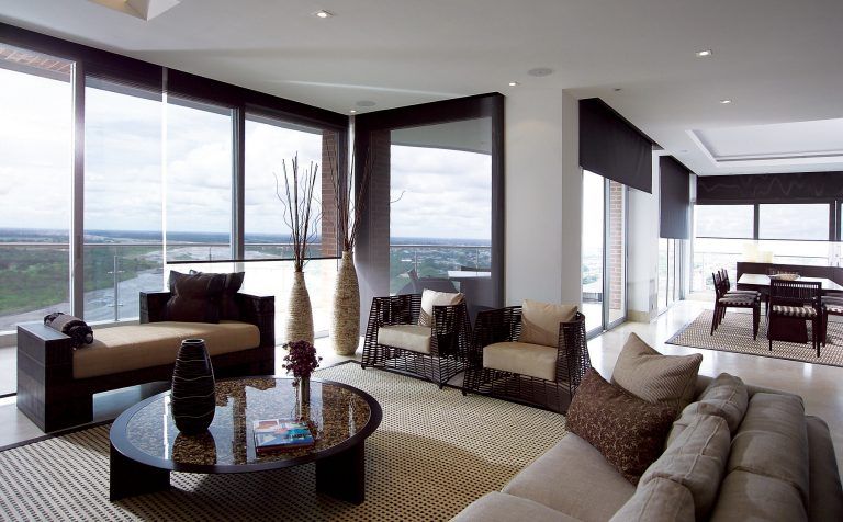 A living room with a couch and chairs and a table