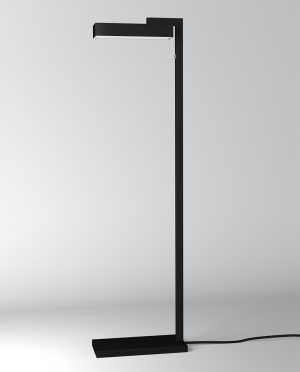 A black lamp is sitting on a white surface