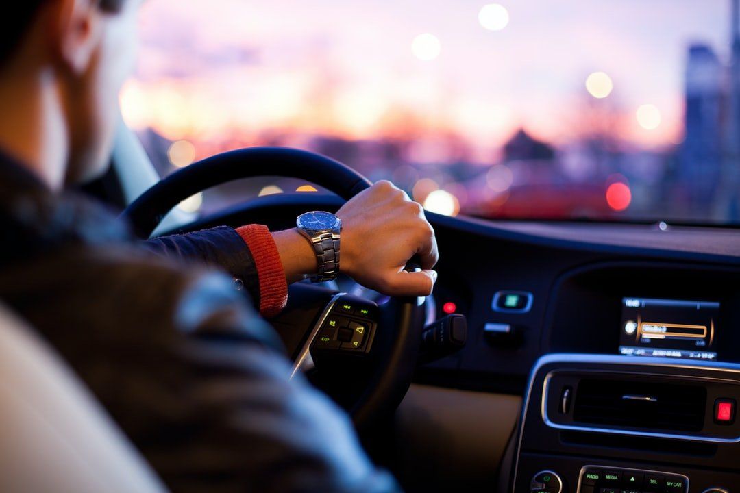 A man is driving a car at night, representing the topic of DUI defense law.