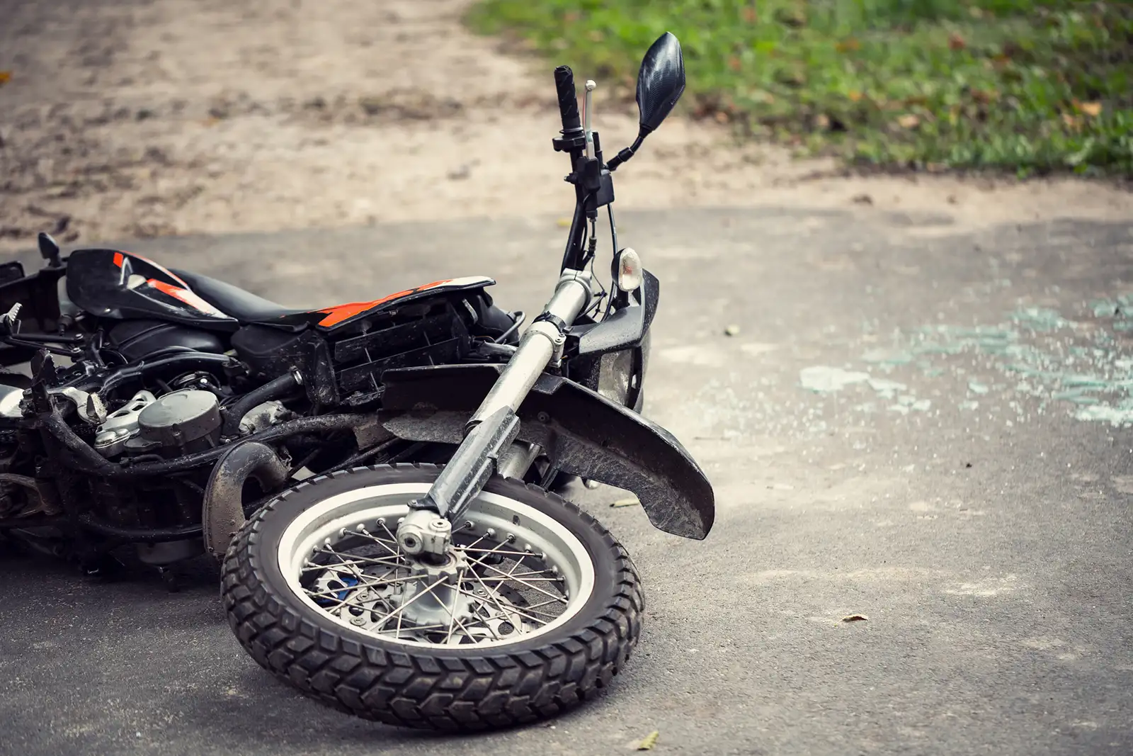 A motorcycle has crashed on the side of the road.
