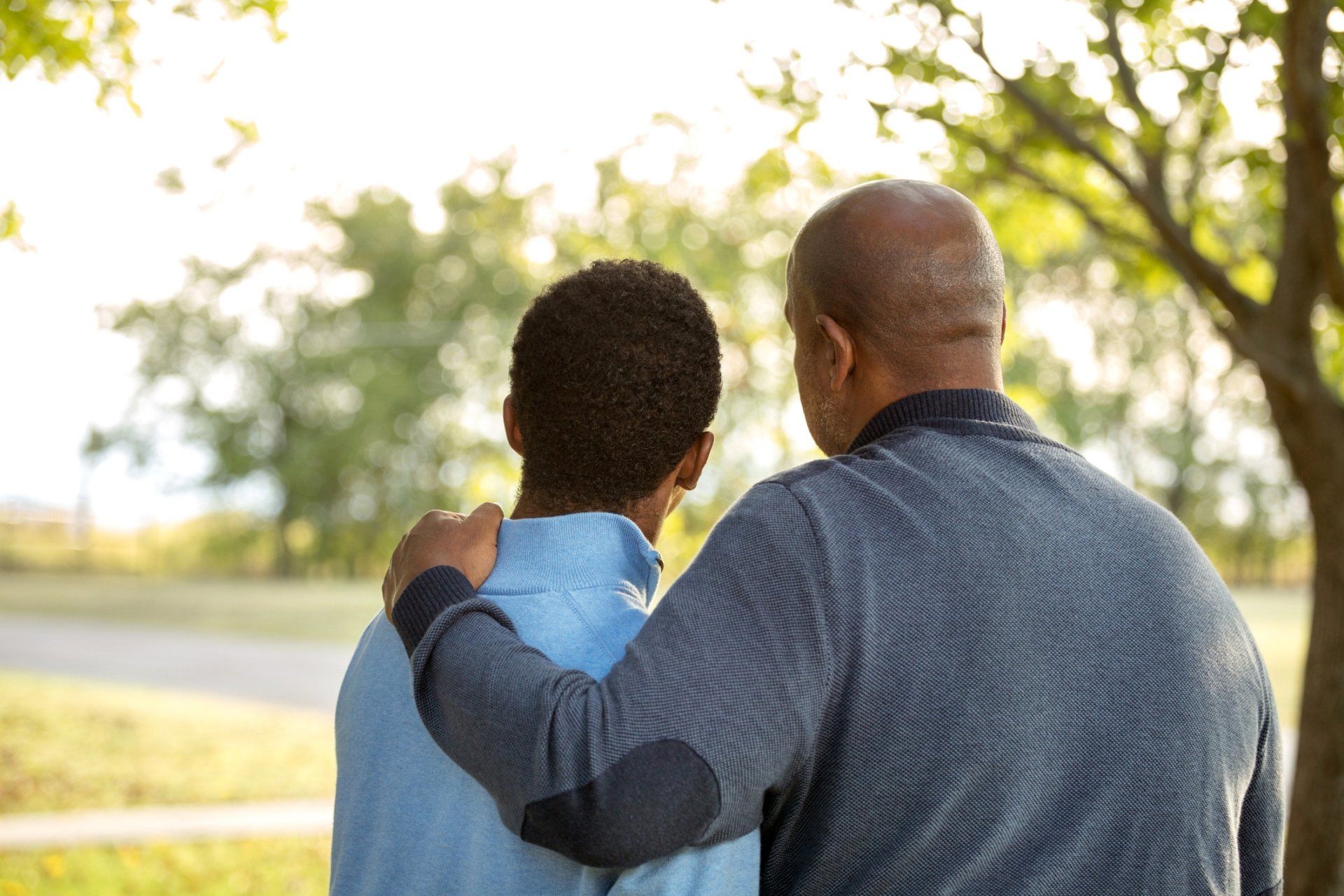 A man and a boy are consoling one another, representing the topic of wrongful death in personal injury law.