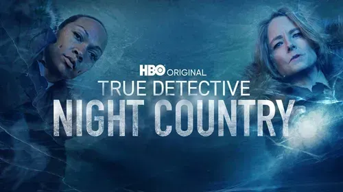 "True Detective: Night Country" poster. Two women, one dark-skinned, the other light-skinned, face forward against a blue backdrop.