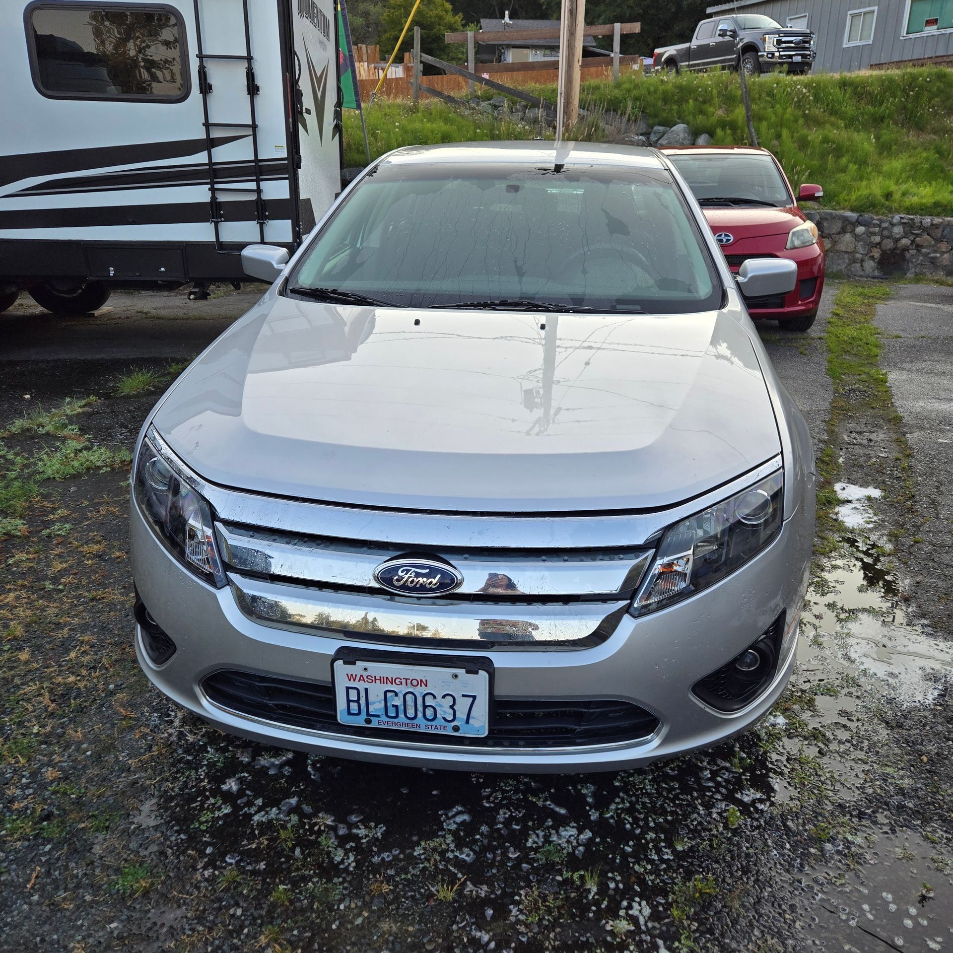 A silver ford car with a california license plate