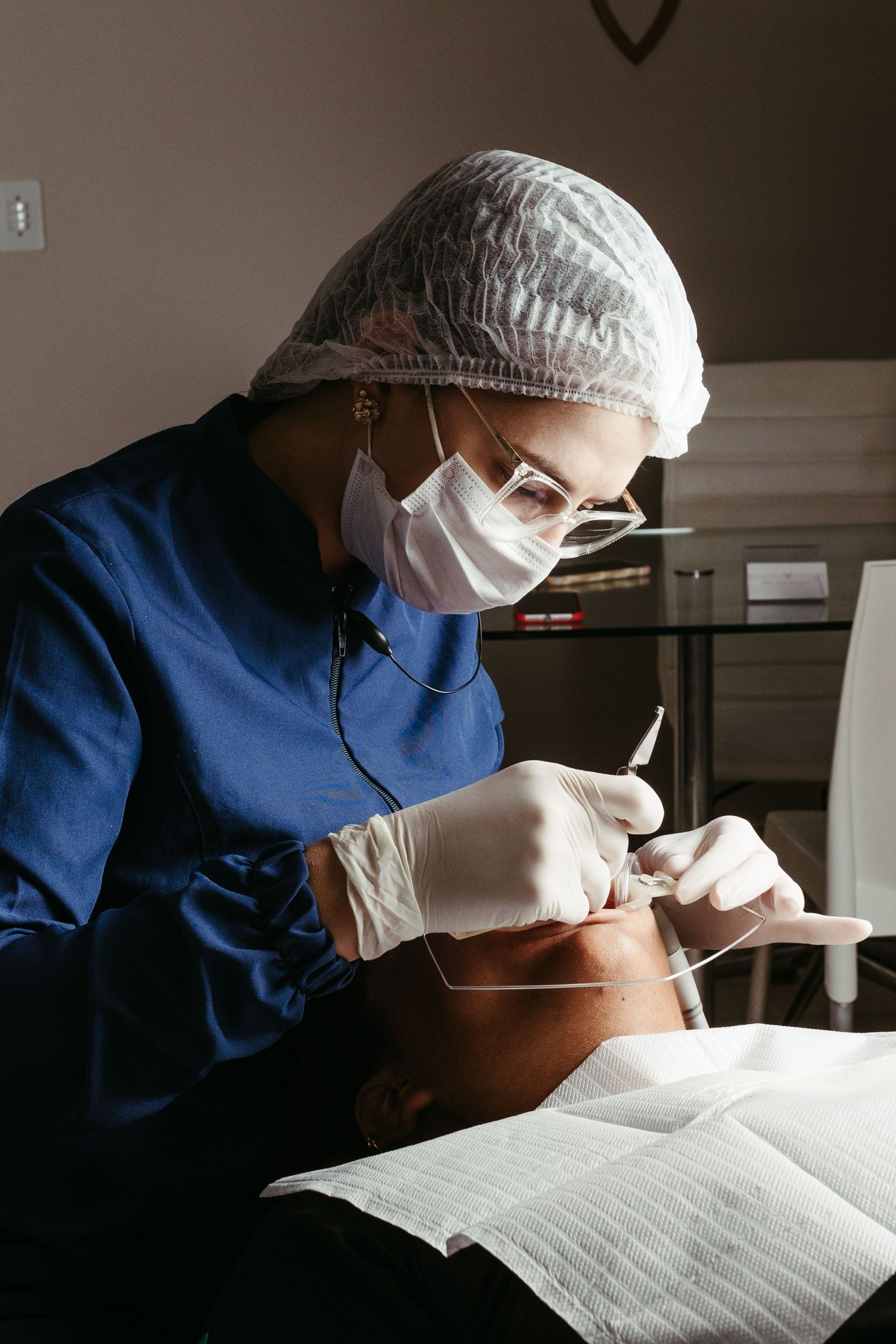 Close-up of a professional dental tool set and a healthy restored tooth model.