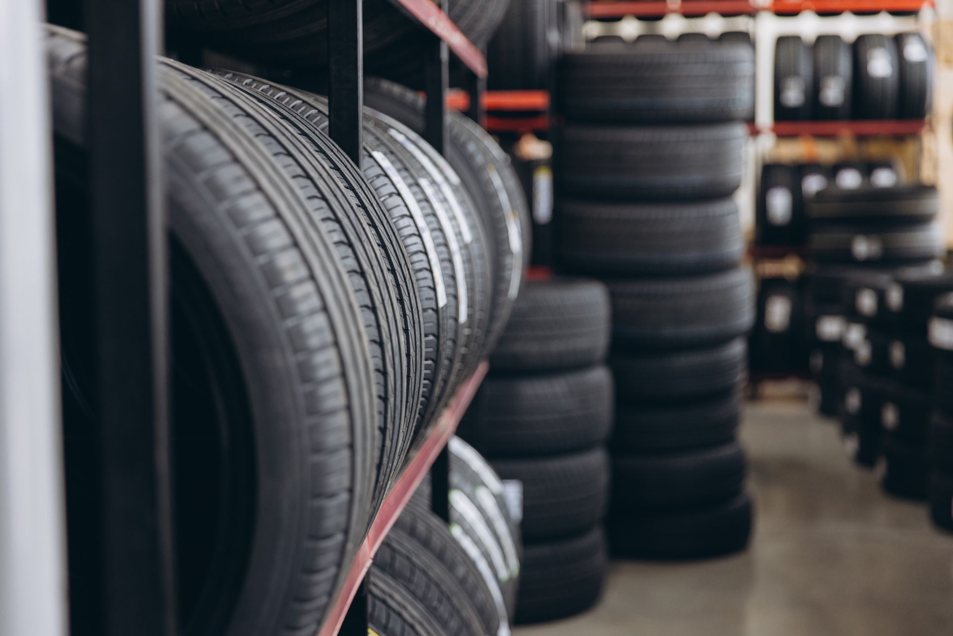 Rows of car tires stacked in a warehouse aisle