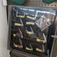 Pegboard-mounted black display with rows of small yellow-and-white tools or clips in clear packaging