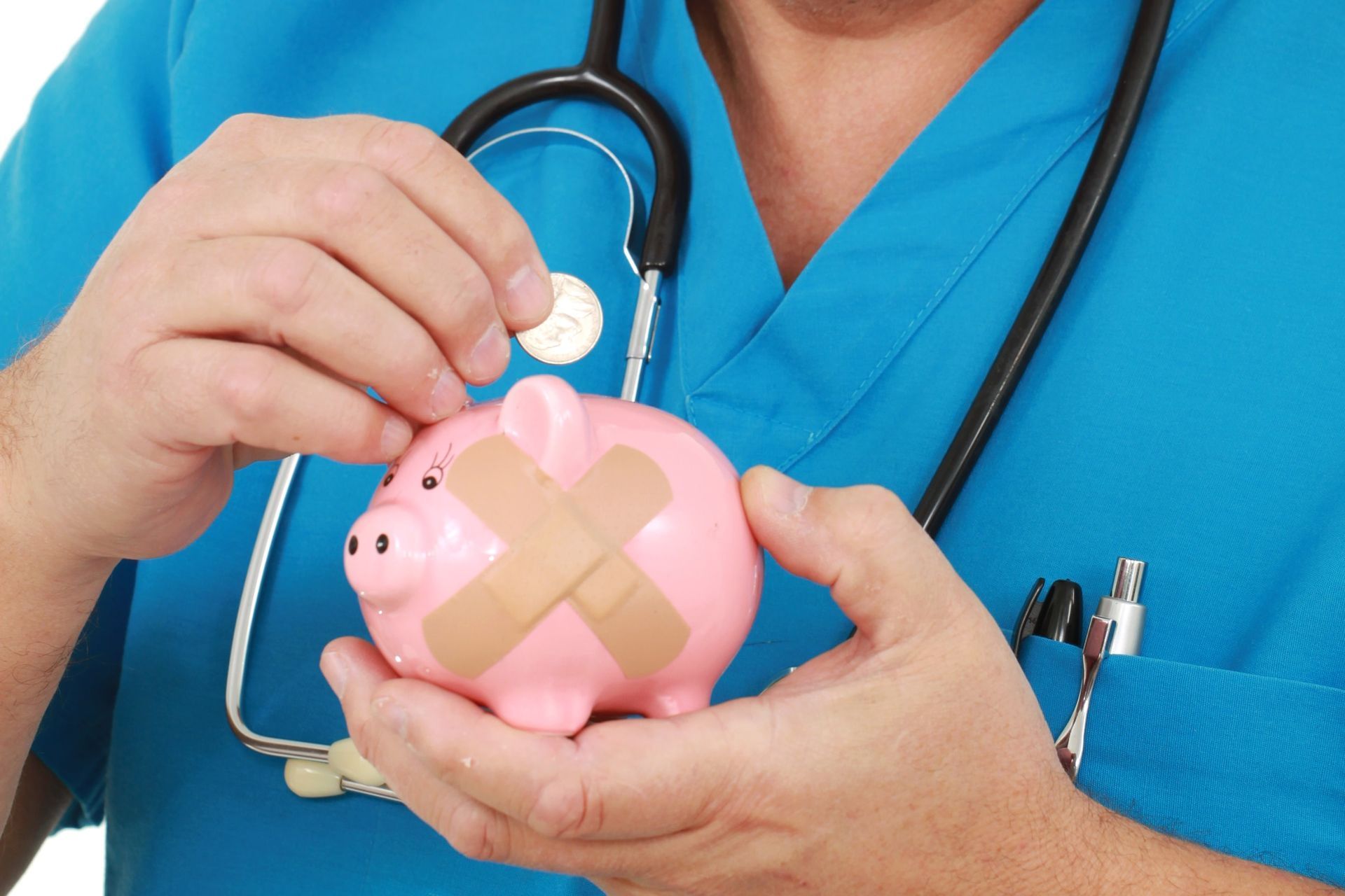 Doctor in blue scrubs placing a coin into a pink piggy bank with bandages.