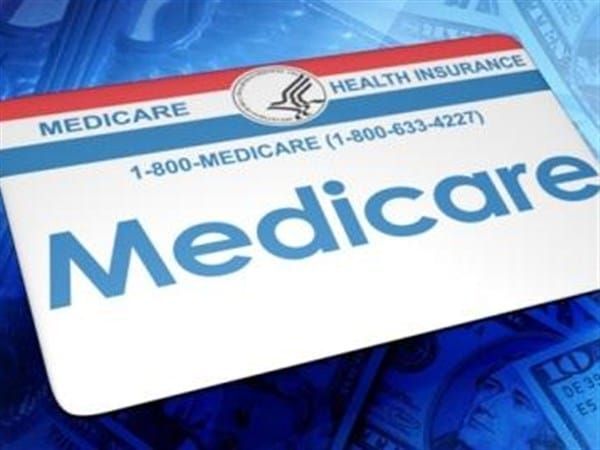 Medicare health insurance card on blue background.