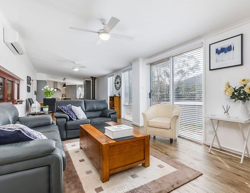 Bright Living Room with Gray Sofas, Wooden Coffee Table, Large Windows — Rivbuild In Uranquinty, NSW