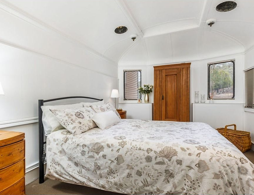 Bright Bedroom with A Double Bed, Floral Bedding, Wooden Wardrobe — Rivbuild In Uranquinty, NSW