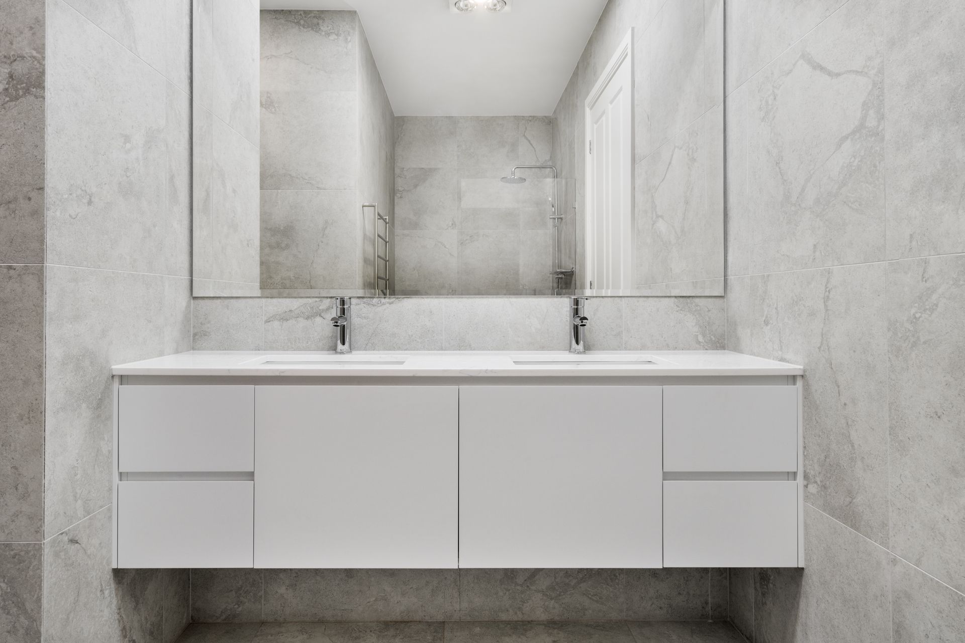 Modern White Bathroom Vanity with Mirror and Marble-Look Wall Tiles — Rivbuild In Uranquinty, NSW