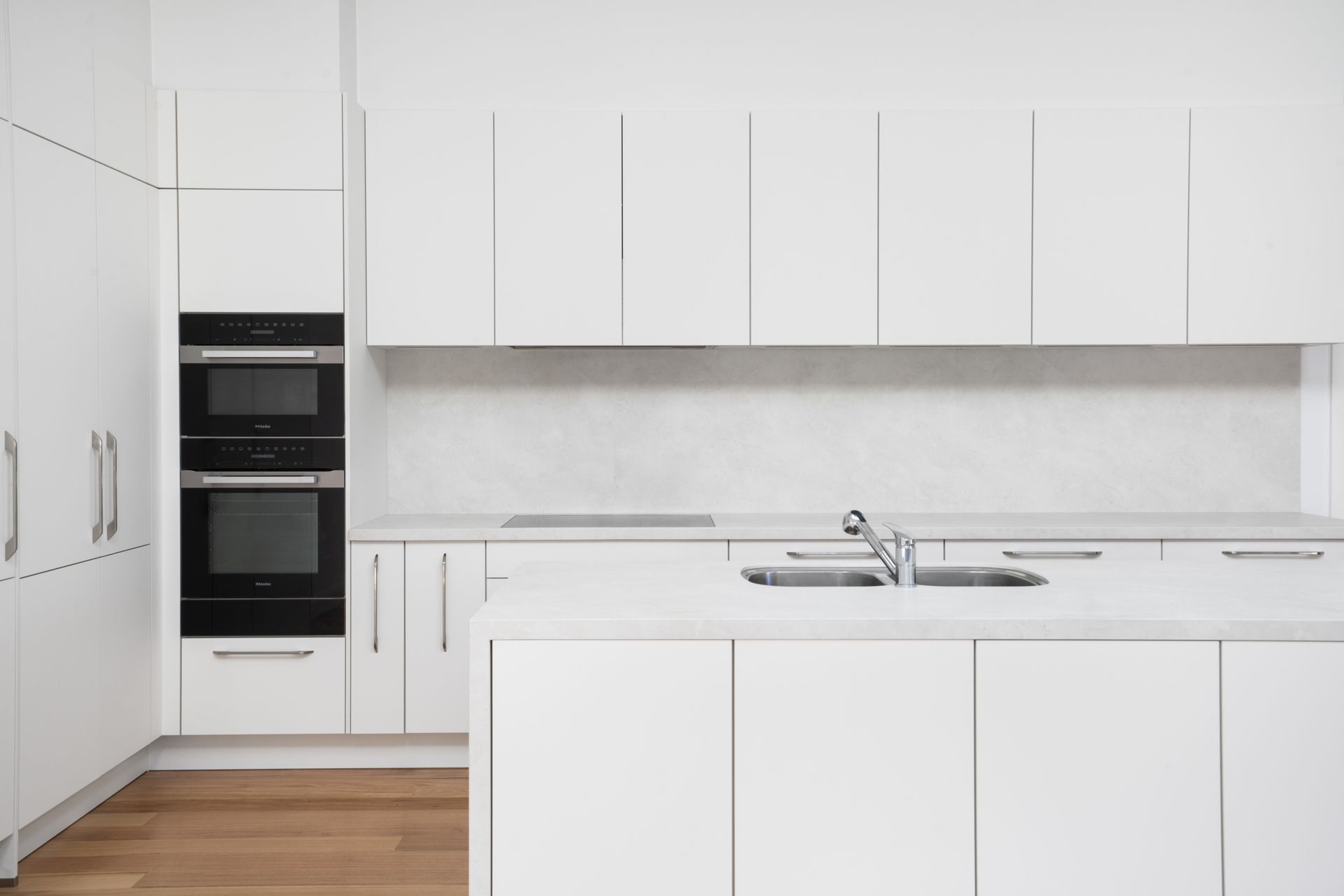 Modern White Kitchen with Built-In Ovens, Island Sink — Rivbuild In Uranquinty, NSW