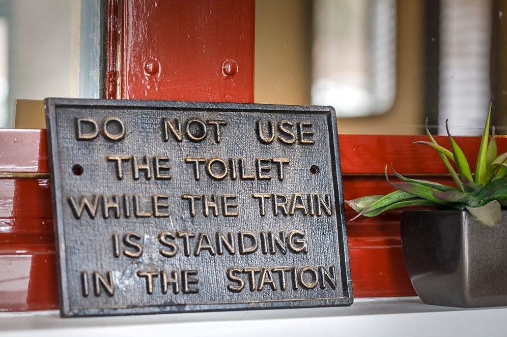Sign Reading “Do Not Use the Toilet While the Train Is Standing in The Station” — Rivbuild In Uranquinty, NSW