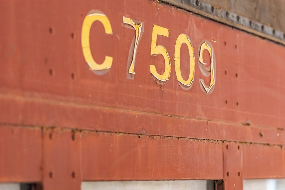 Close-Up of Red Metal Surface with Faded White Stenciled Text “C7509” — Rivbuild In Uranquinty, NSW