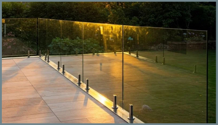 Frameless glass fence in a garden outdoor area with sunlight, showing easy maintenance needs.