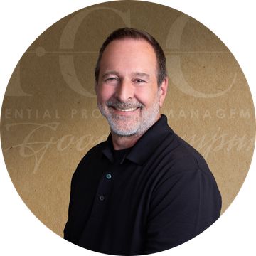 Smiling man in a black shirt, set against a brown background with text.
