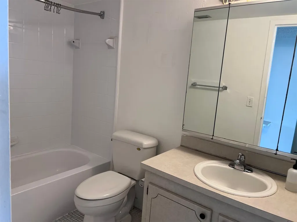Full bathroom at the entrance of bedroom of Unit 703, Ixora Ct, North Miami, FL 33181.