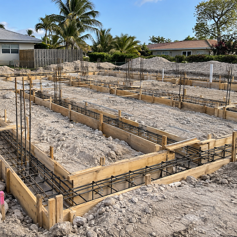 Excavated foundation with rebar and wood forms on a South Florida job site