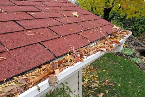 cleaning the roof gutter using the water pressure
