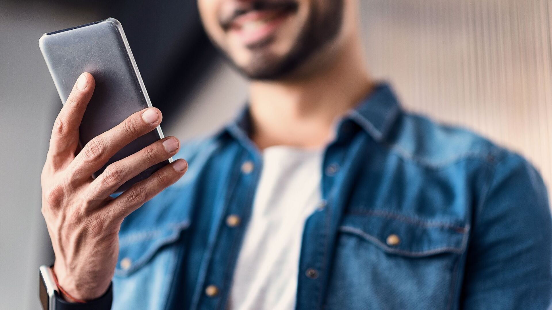 Man looking at his smartphone. home network in 2021