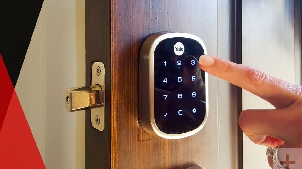 Person using a Yale smart lock keypad on door. how smart locks work
