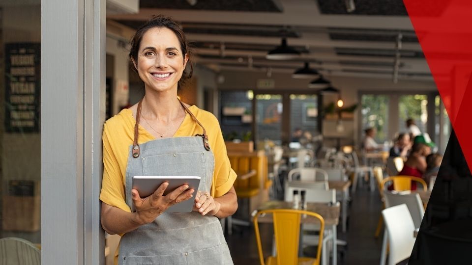 Small business owner standing in front of cafe. small business security system