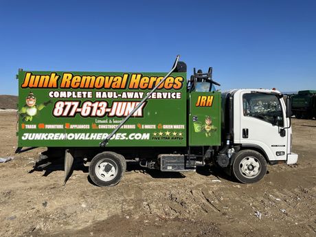 Green and white junk removal truck with 