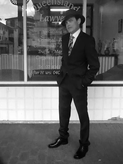 Black And White Photo Of Man In Suit And Fedora — Queensland Lawyers Cairns In Cairns City, QLD