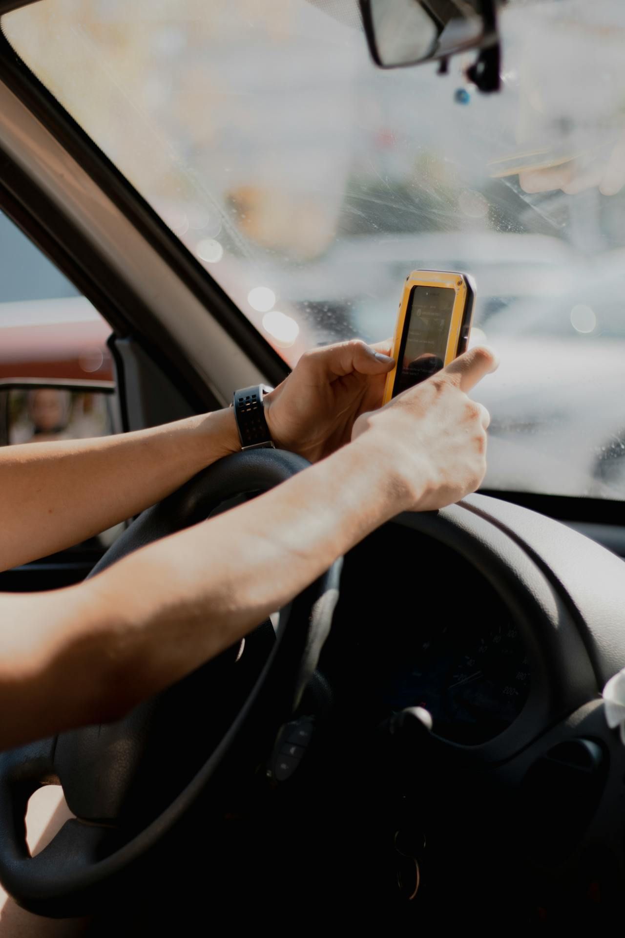 Person Using Their Phone While Driving - Queensland Lawyers In Cairns QLD