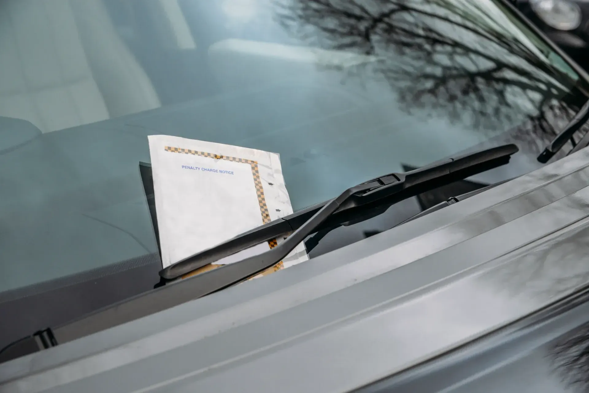 Parking Ticket On Car Windshield Under A Wiper, Viewed Through The Glass - Queensland Lawyers in Cairns QLD