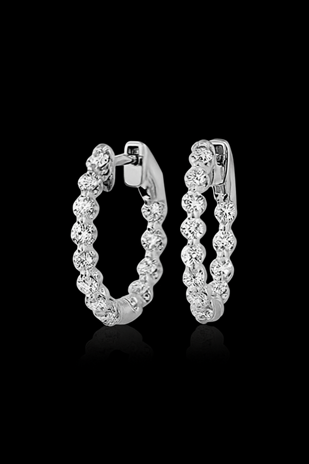 Diamond hoop earrings on black background.
