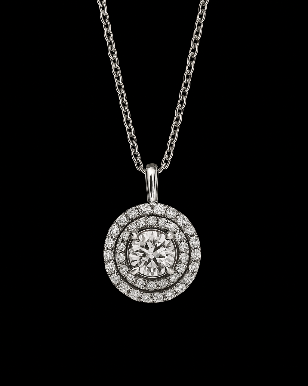 Diamond pendant necklace with a round center stone and a halo of smaller diamonds, on a silver chain.