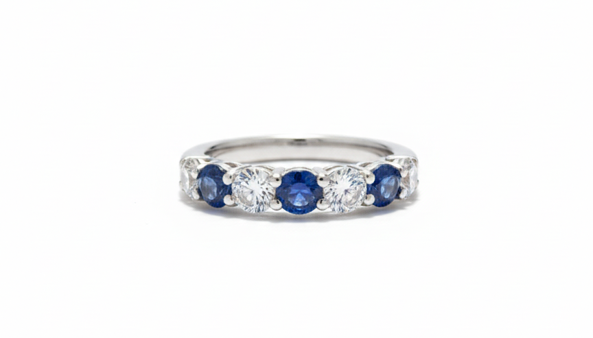 White gold ring with three blue sapphires and alternating white diamonds.